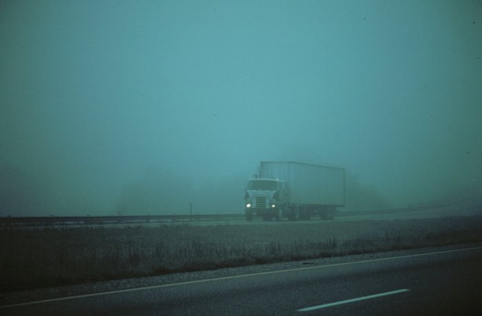truck driving through fog